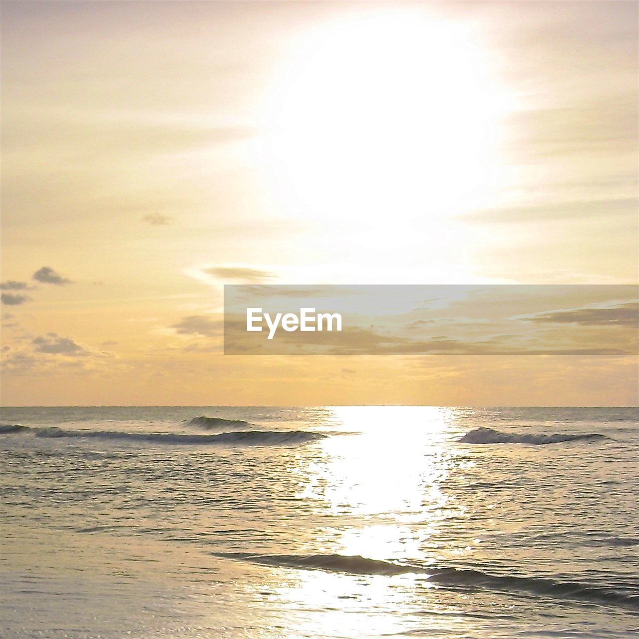 SCENIC VIEW OF BEACH AGAINST SKY AT SUNSET