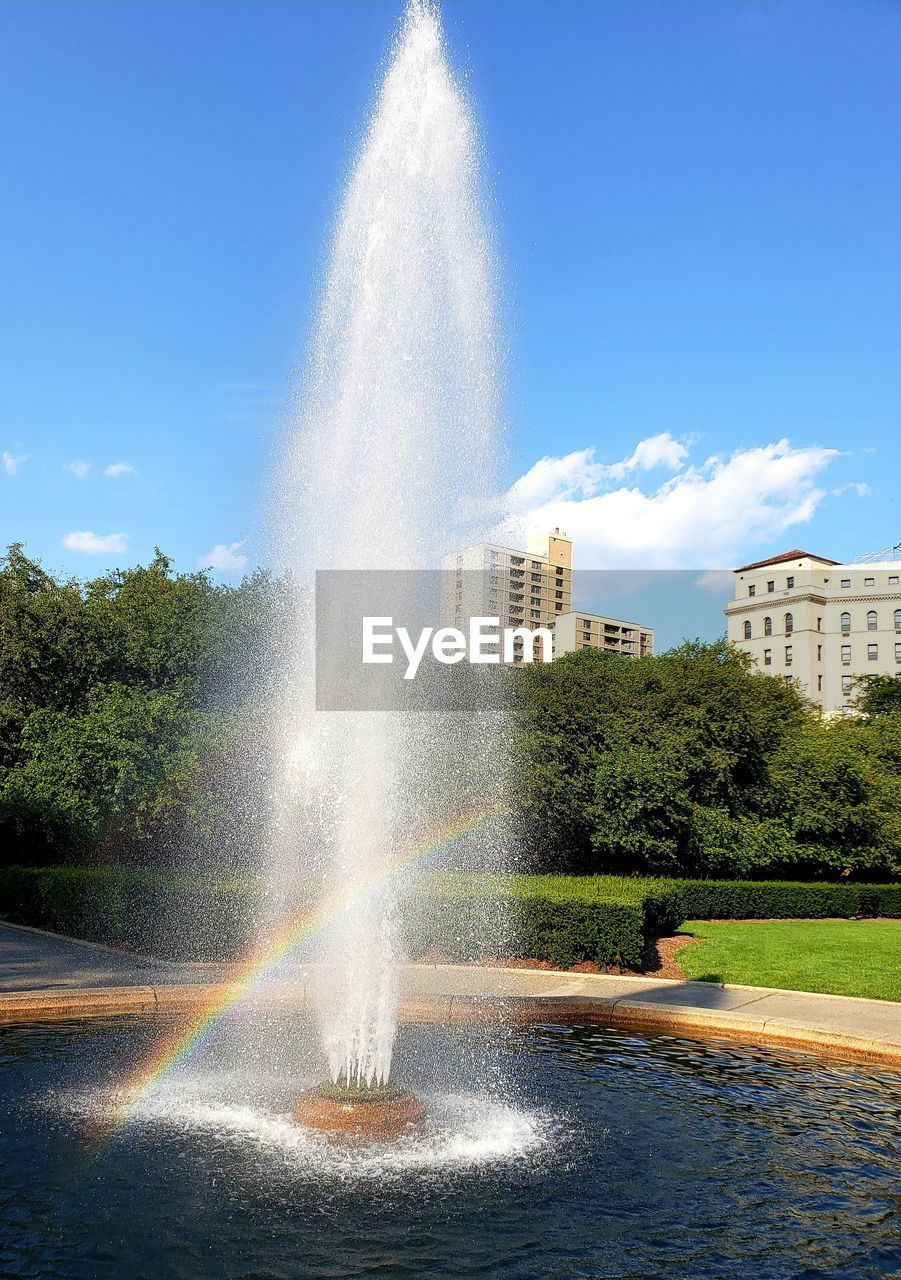 WATER SPLASHING ON FOUNTAIN AGAINST SKY