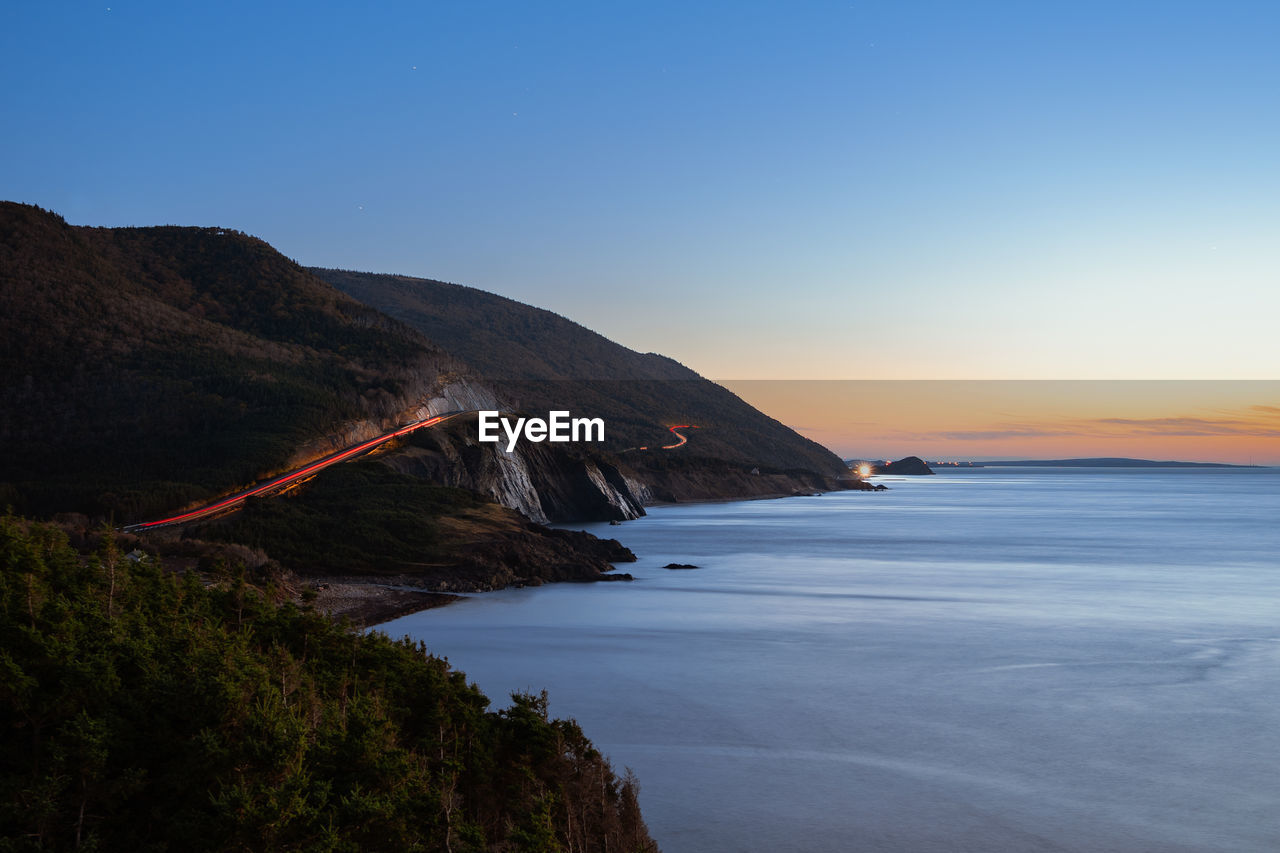 Scenic view of sea against sky during sunset along the cabot trail of nova scotia, canada