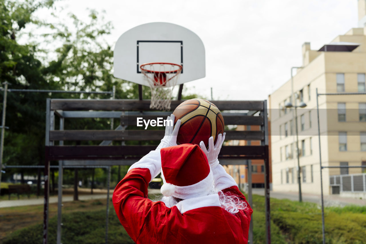 Santa claus throwing a triple with his basketball