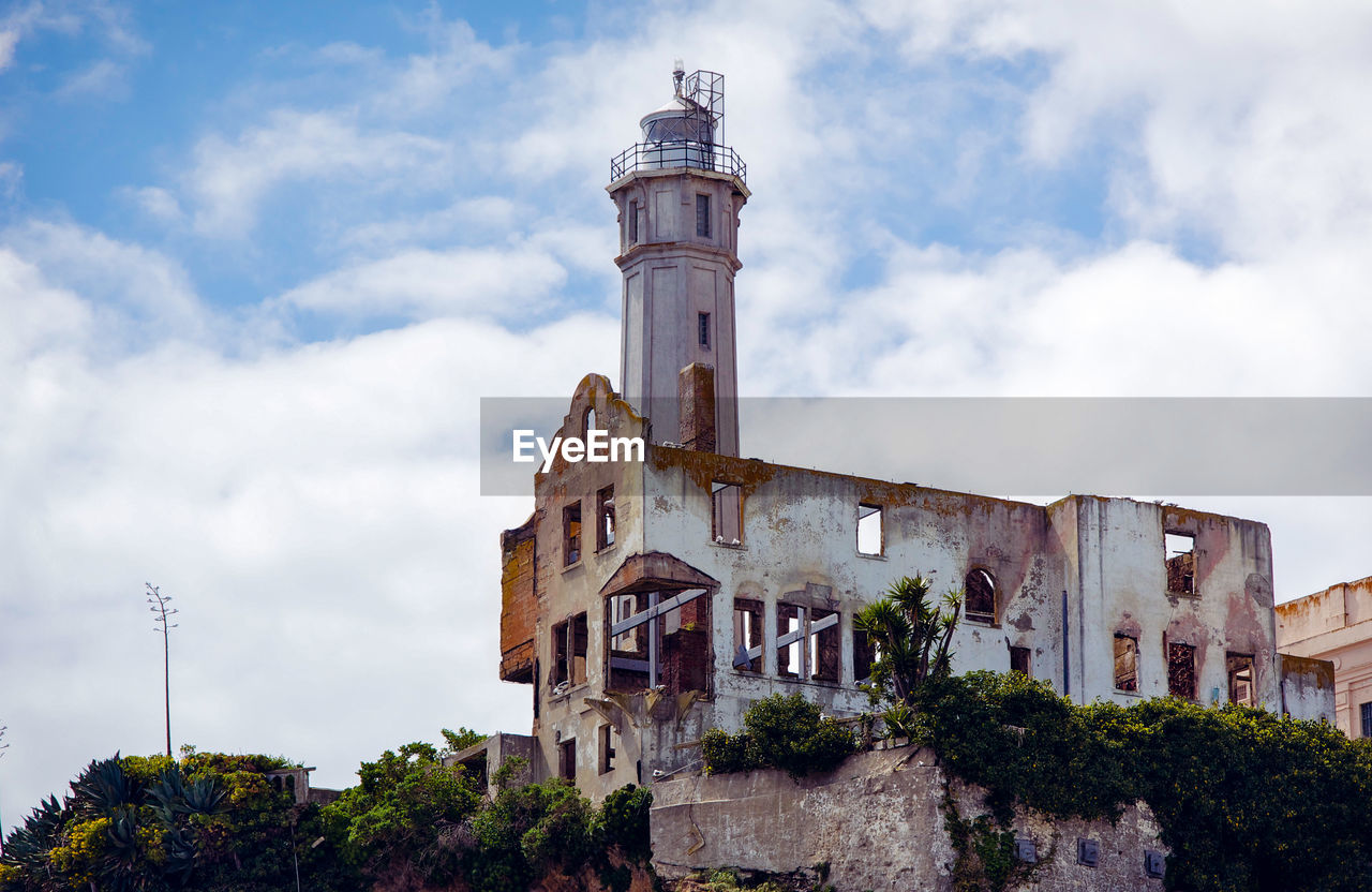 Low angle view of old abandoned prison building at alcatraz island against sky