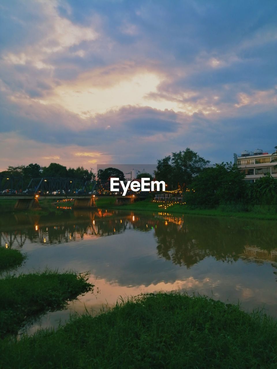 Scenic view of lake against sky at sunset