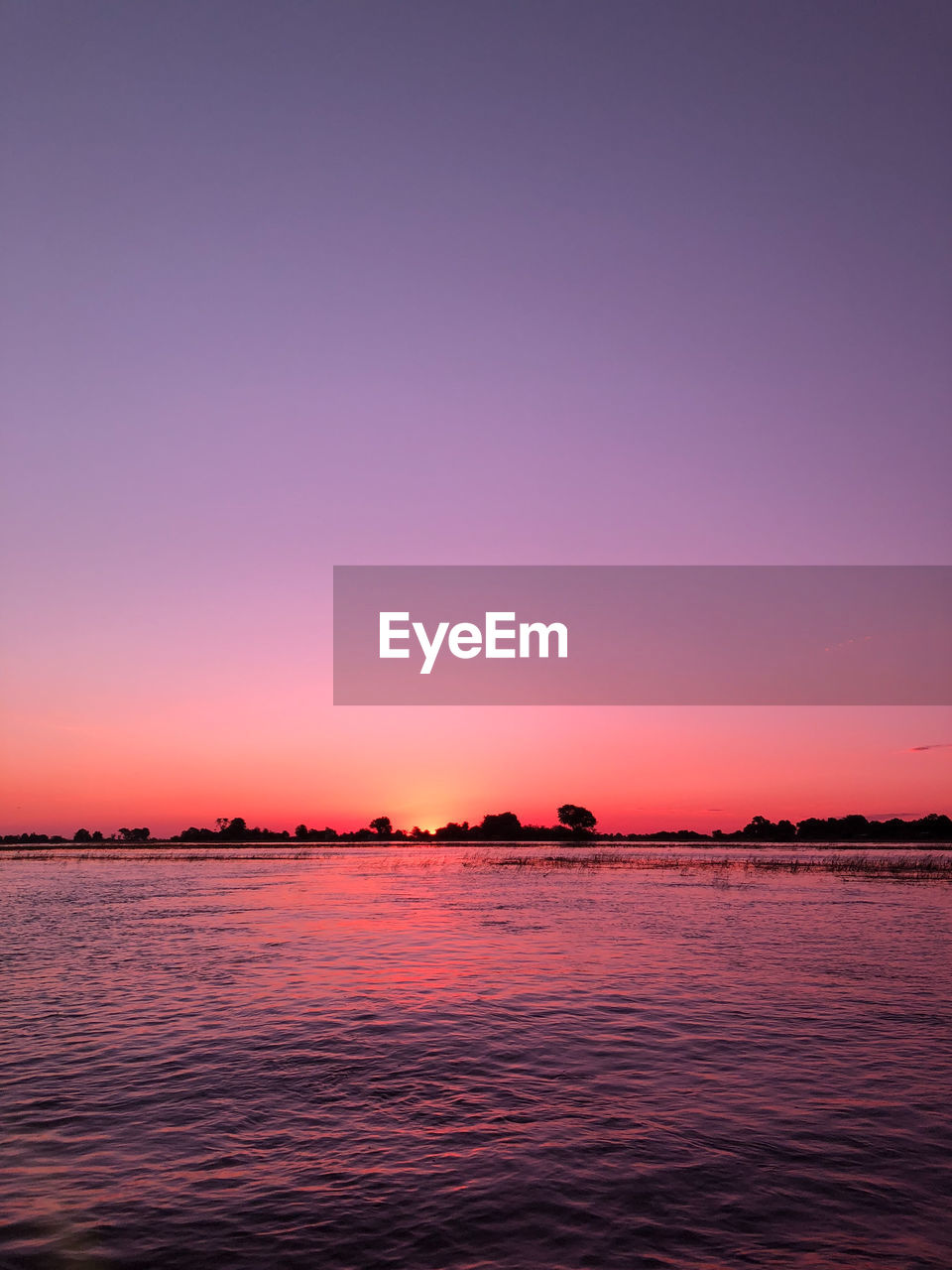 SCENIC VIEW OF SEA AGAINST ORANGE SKY