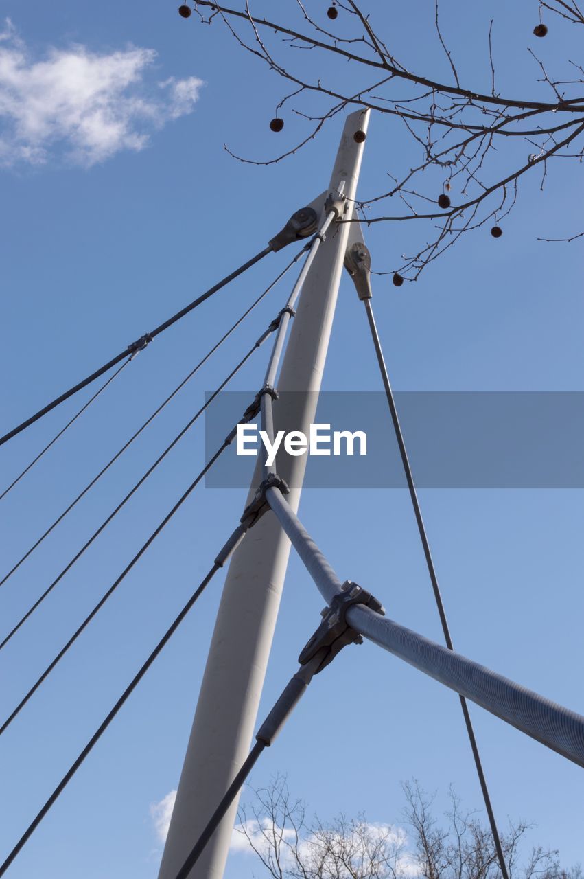 LOW ANGLE VIEW OF SUSPENSION BRIDGE AGAINST BLUE SKY