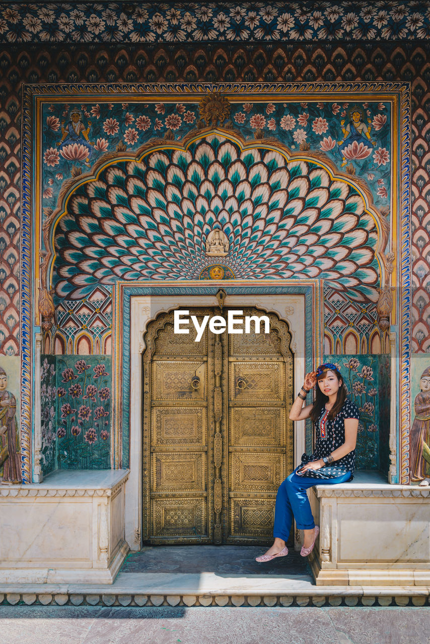 Woman sitting outside temple