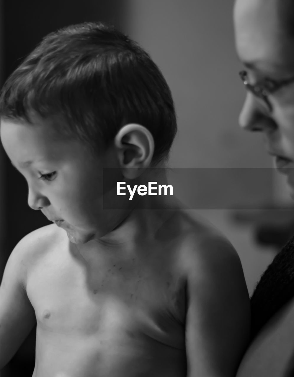 Close-up of mother and son looking down