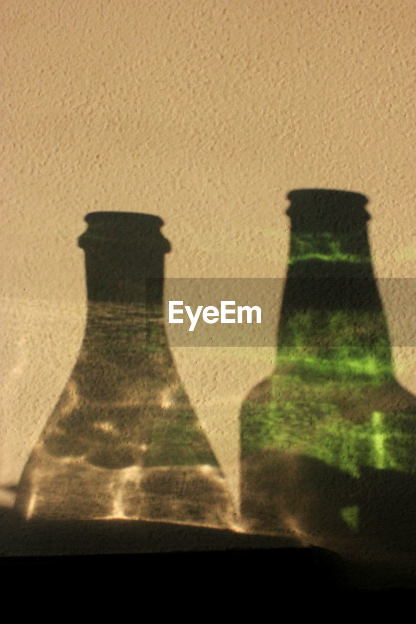 SHADOW OF PERSON ON GLASS TABLE