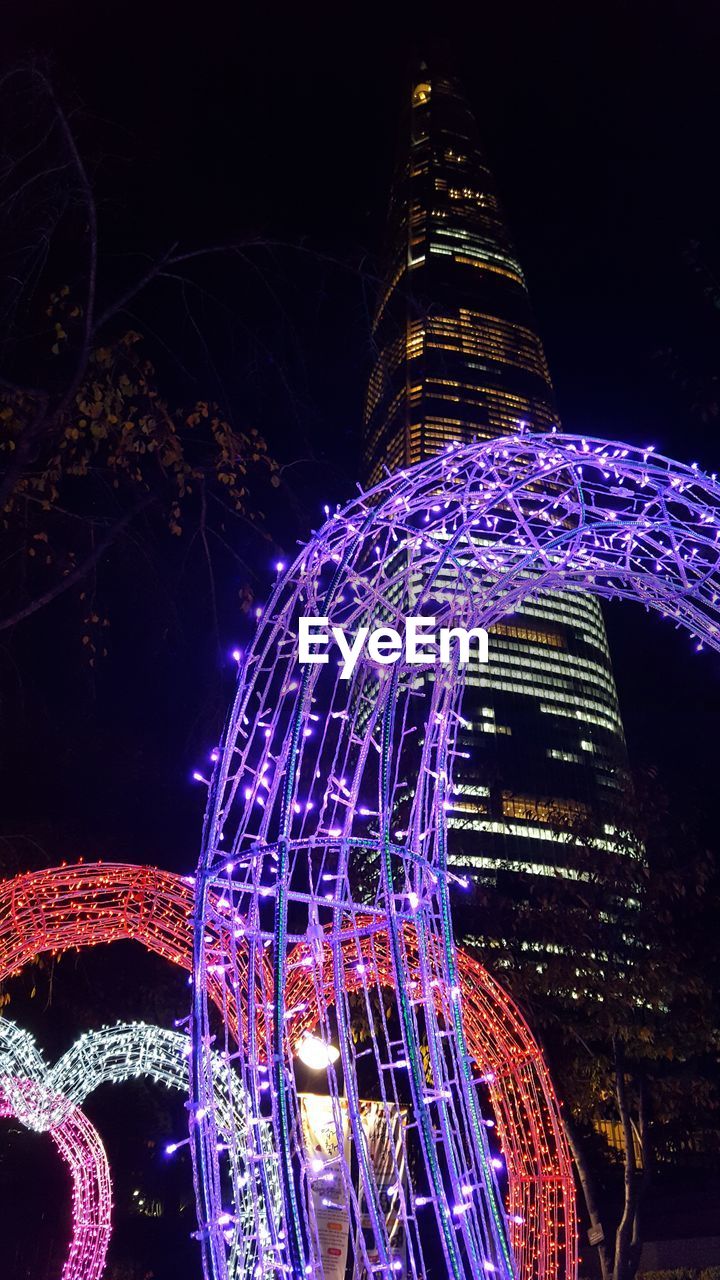 LOW ANGLE VIEW OF ILLUMINATED CAROUSEL