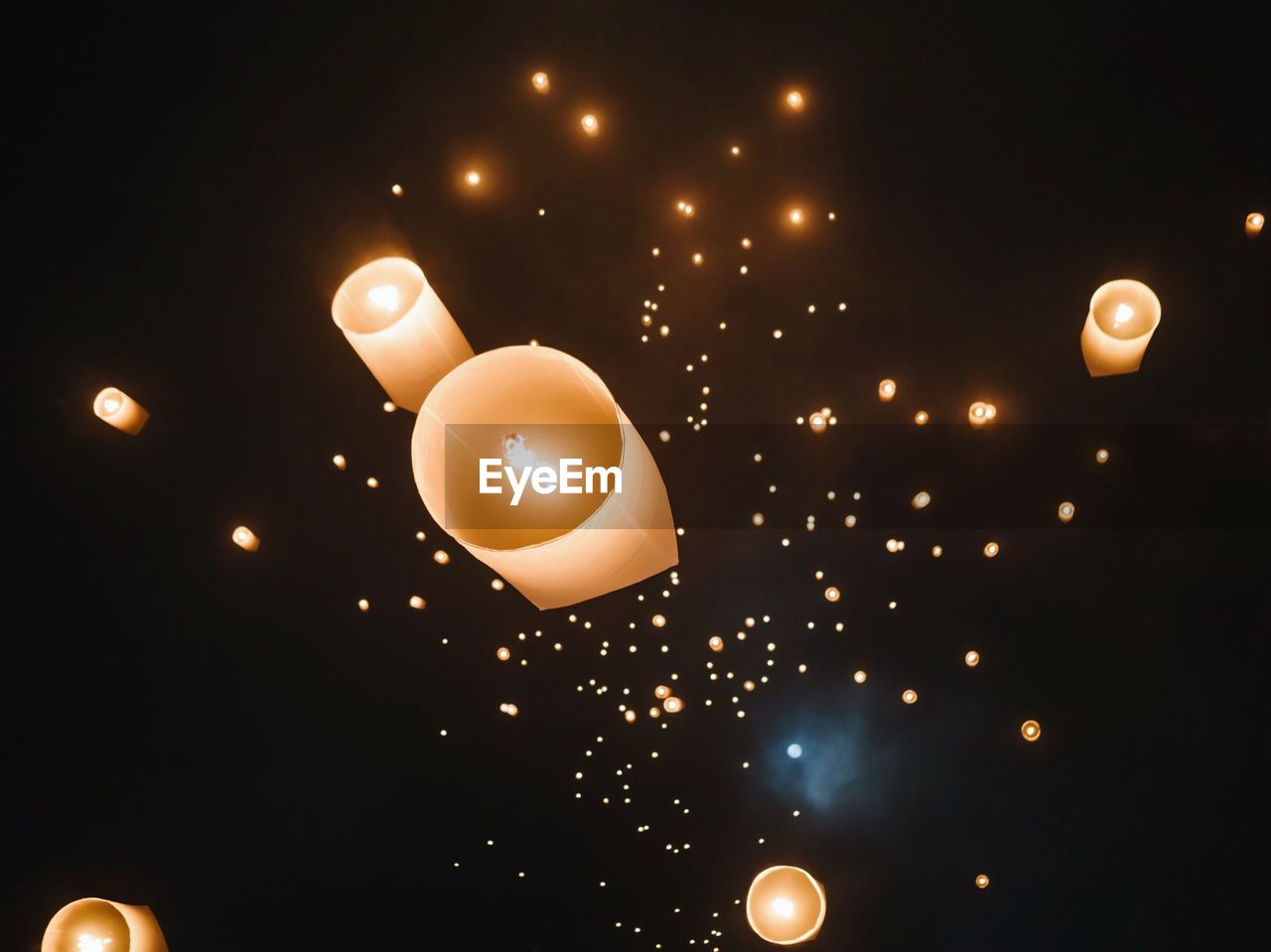 Directly below shot of chinese lanterns flying in sky at night