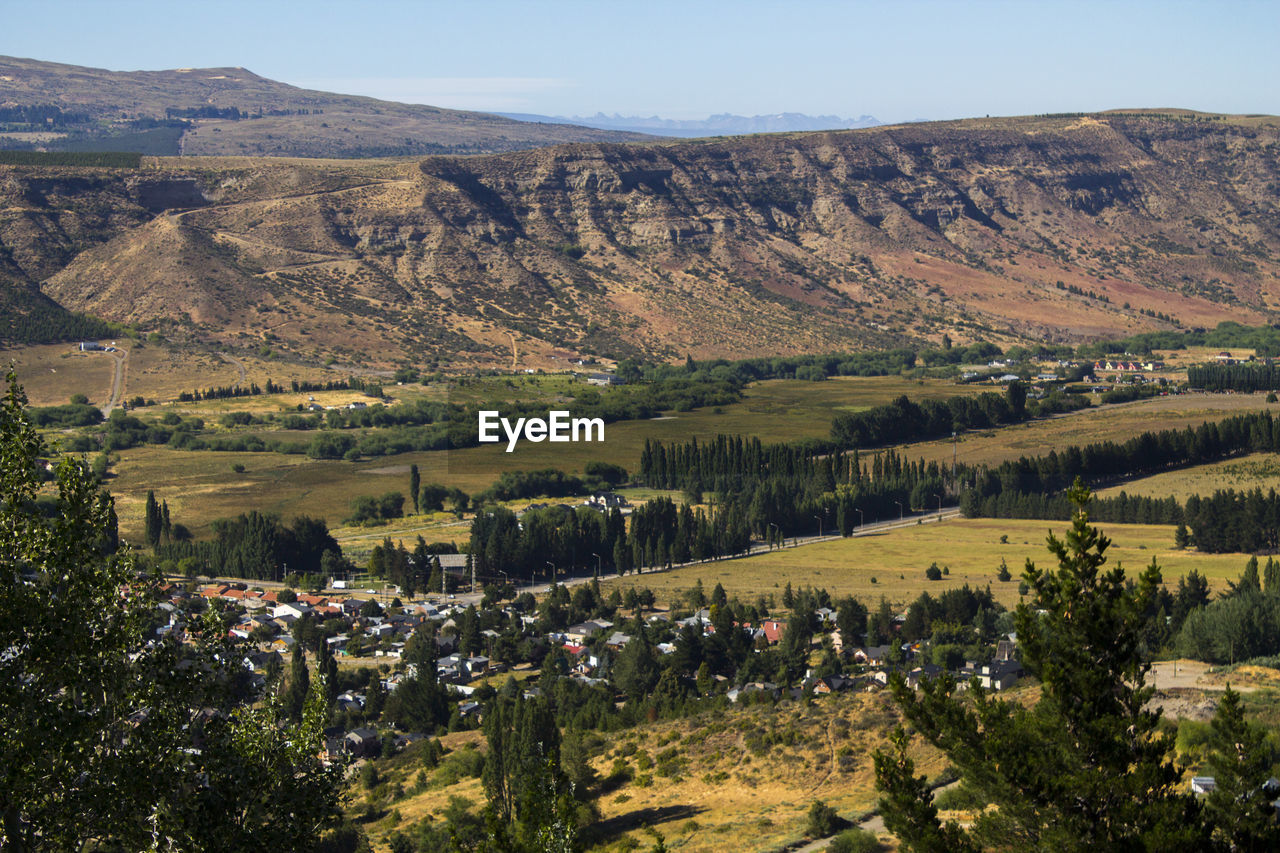 Scenic view of trees and mountains against sky