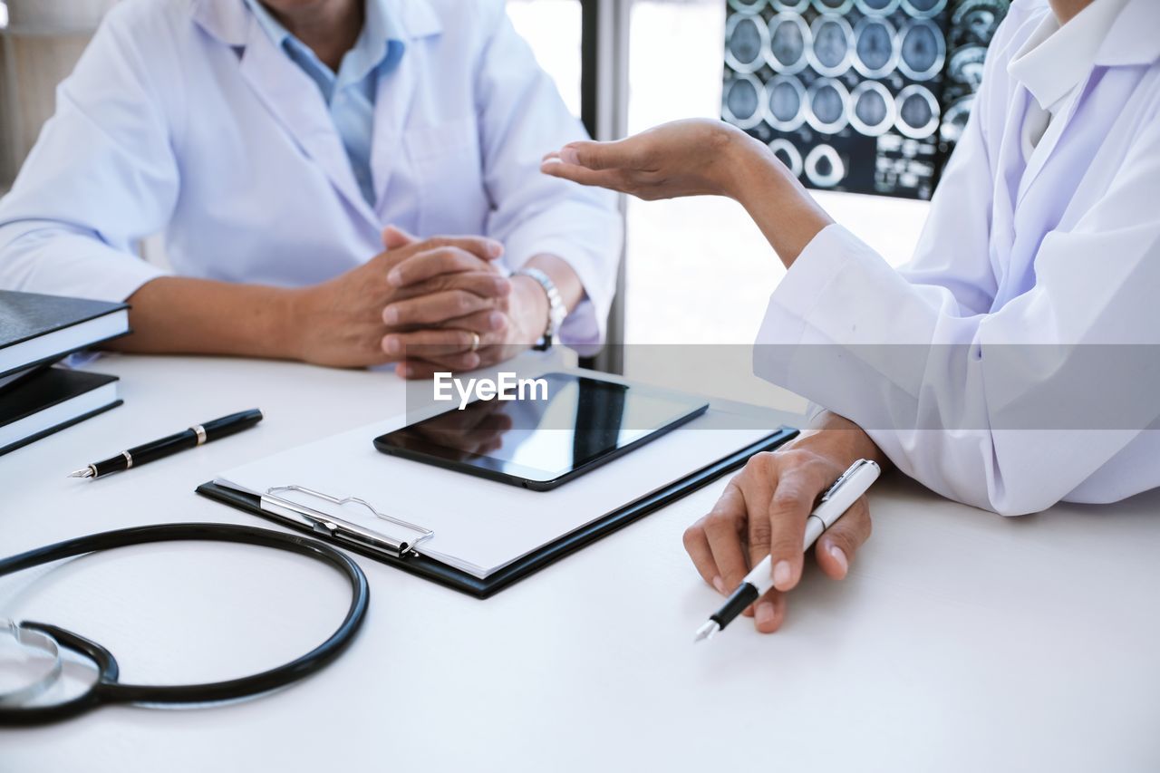 midsection of doctor examining patient in hospital