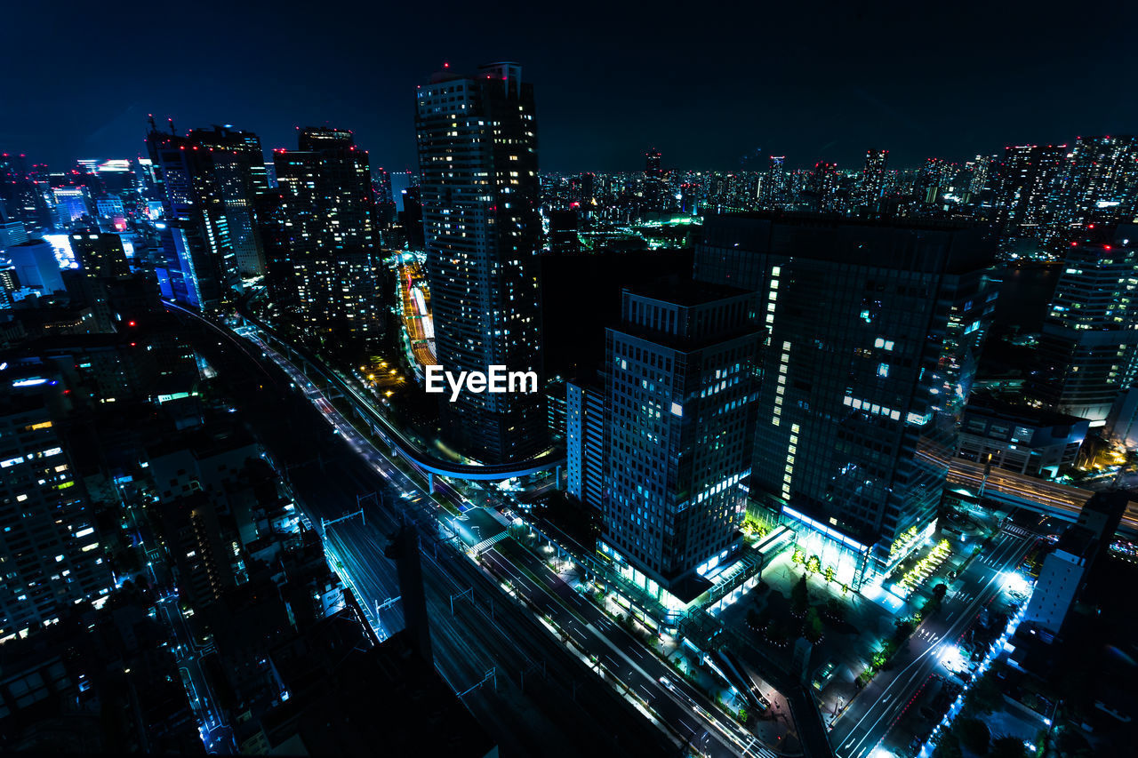 High angle view of illuminated city buildings at night