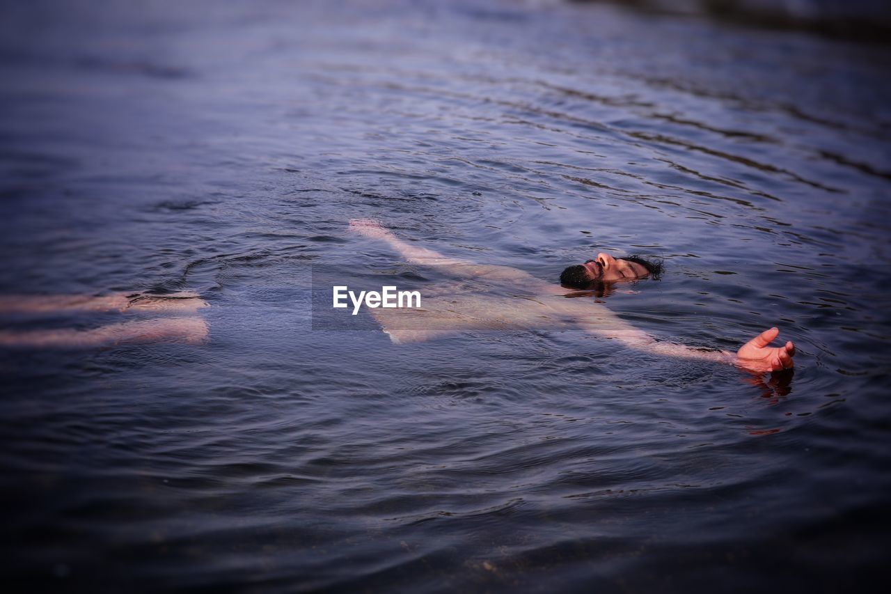 High angle view of man swimming in sea