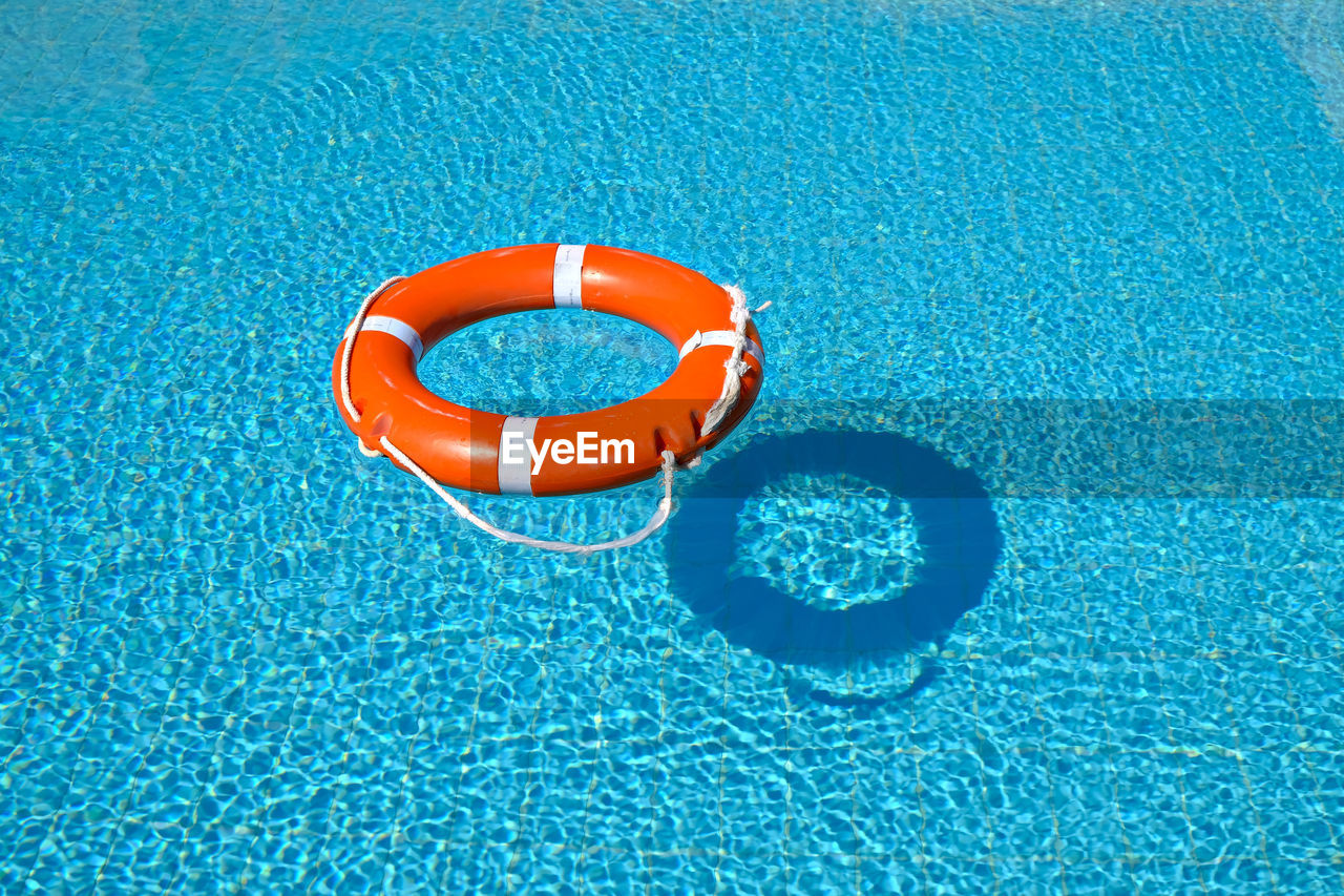 High angle view of life belt floating on swimming pool