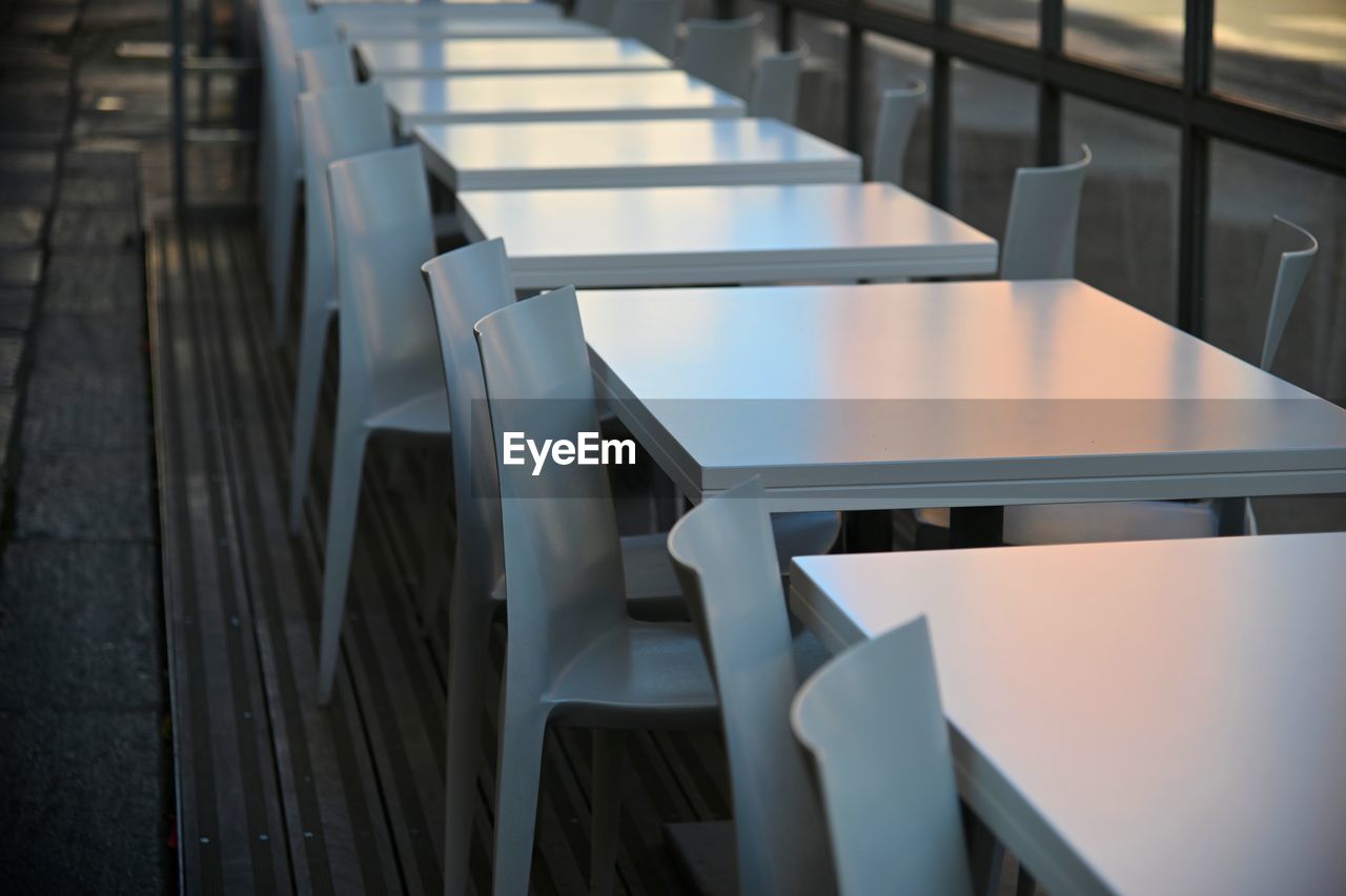 Empty chairs and tables in restaurant terrace
