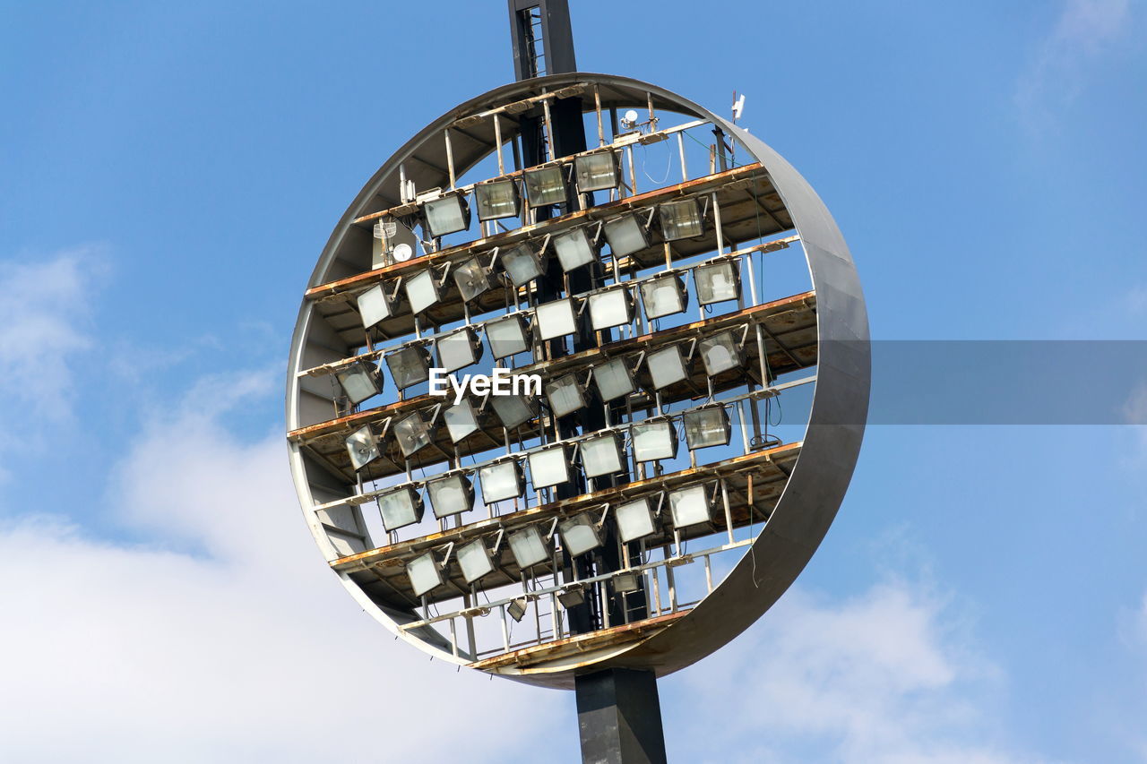 Low angle view of floodlights against sky