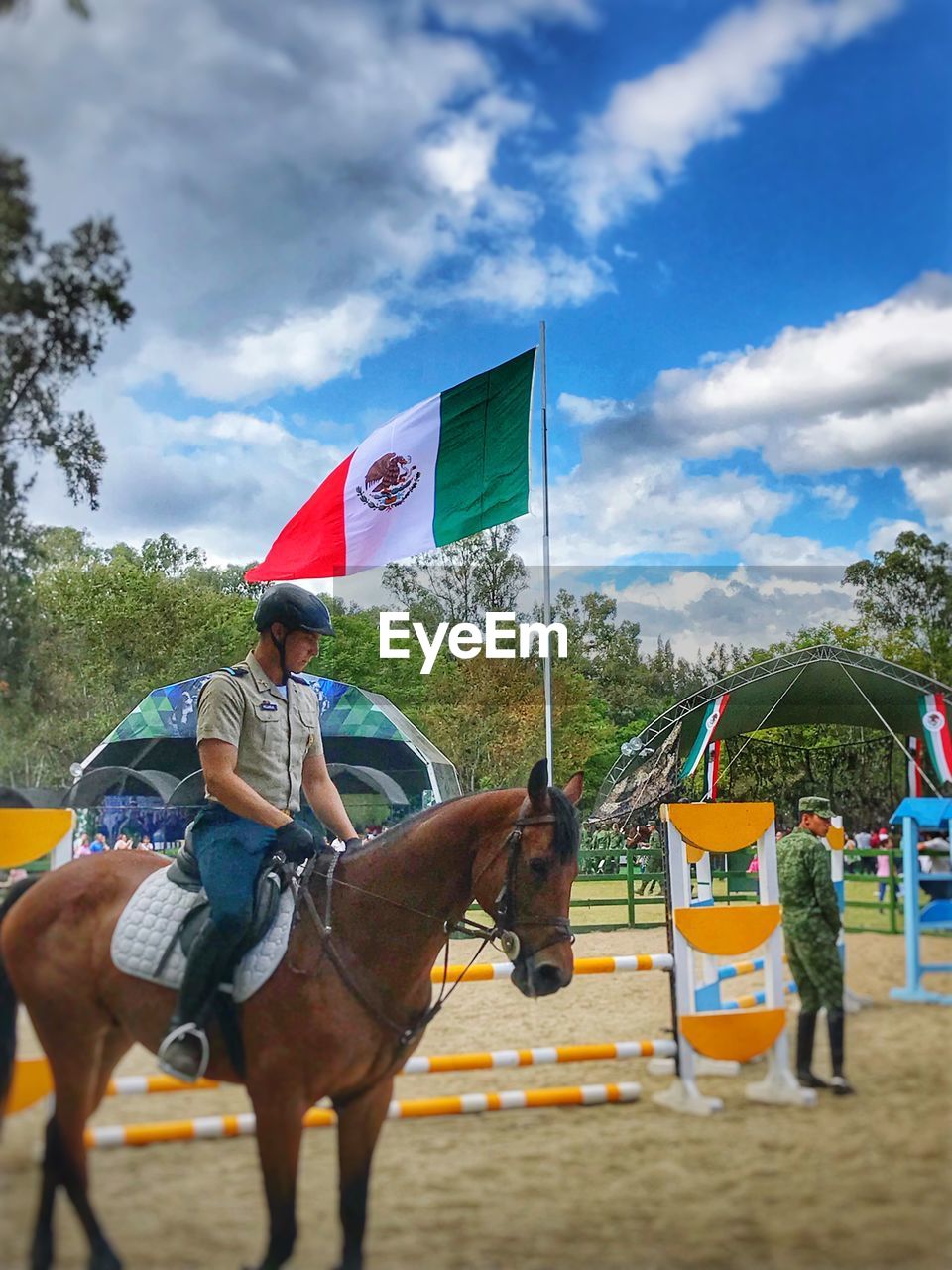 PEOPLE RIDING HORSES AT BEACH