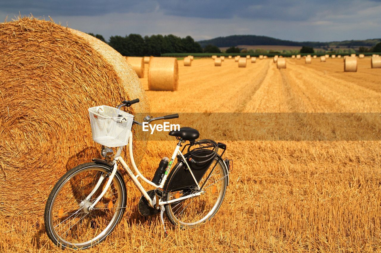 Hay bales on field against sky