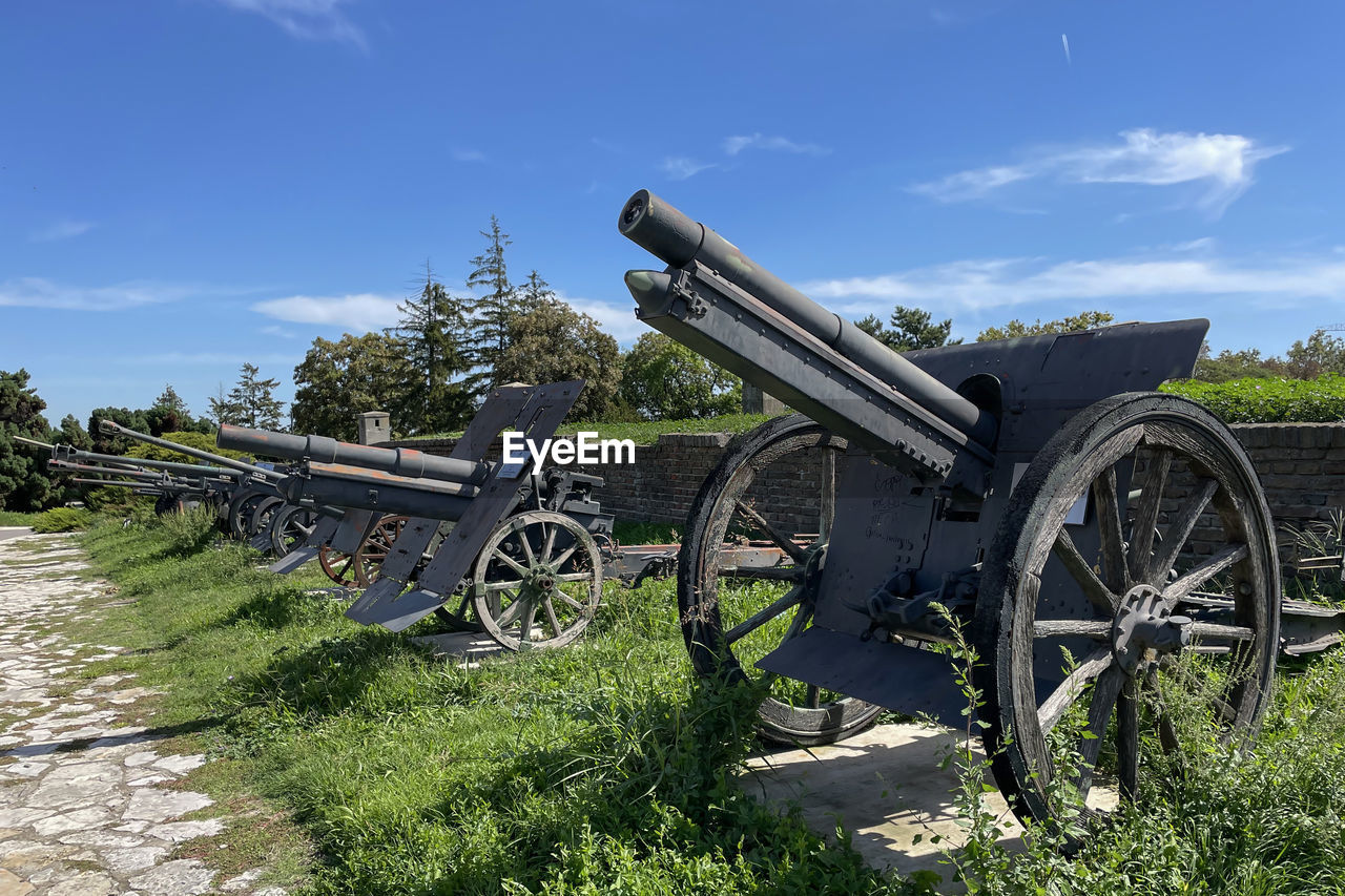 cannon, weapon, sky, the past, history, war, fighting, nature, conflict, plant, transportation, no people, vehicle, cloud, wheel, day, military, grass, old, field, land, outdoors, landscape, sunlight, architecture, rural scene, transport, mode of transportation, metal