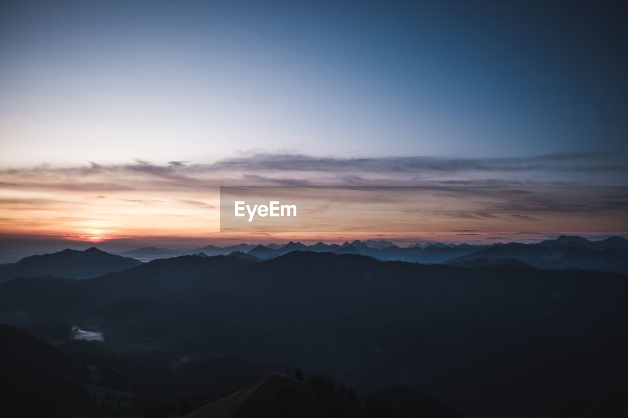 Scenic view of silhouette mountains against sky during sunset