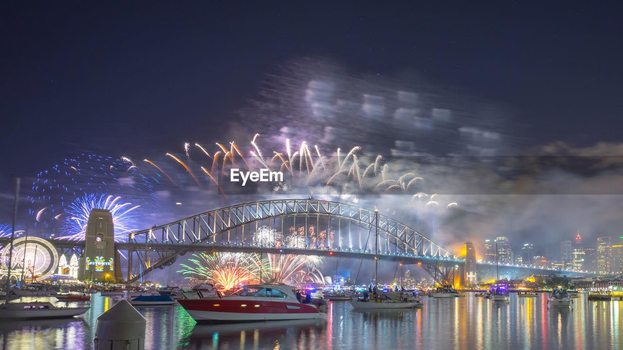 Firework display in city at night