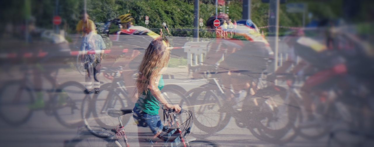 REAR VIEW OF WOMAN ON ROAD