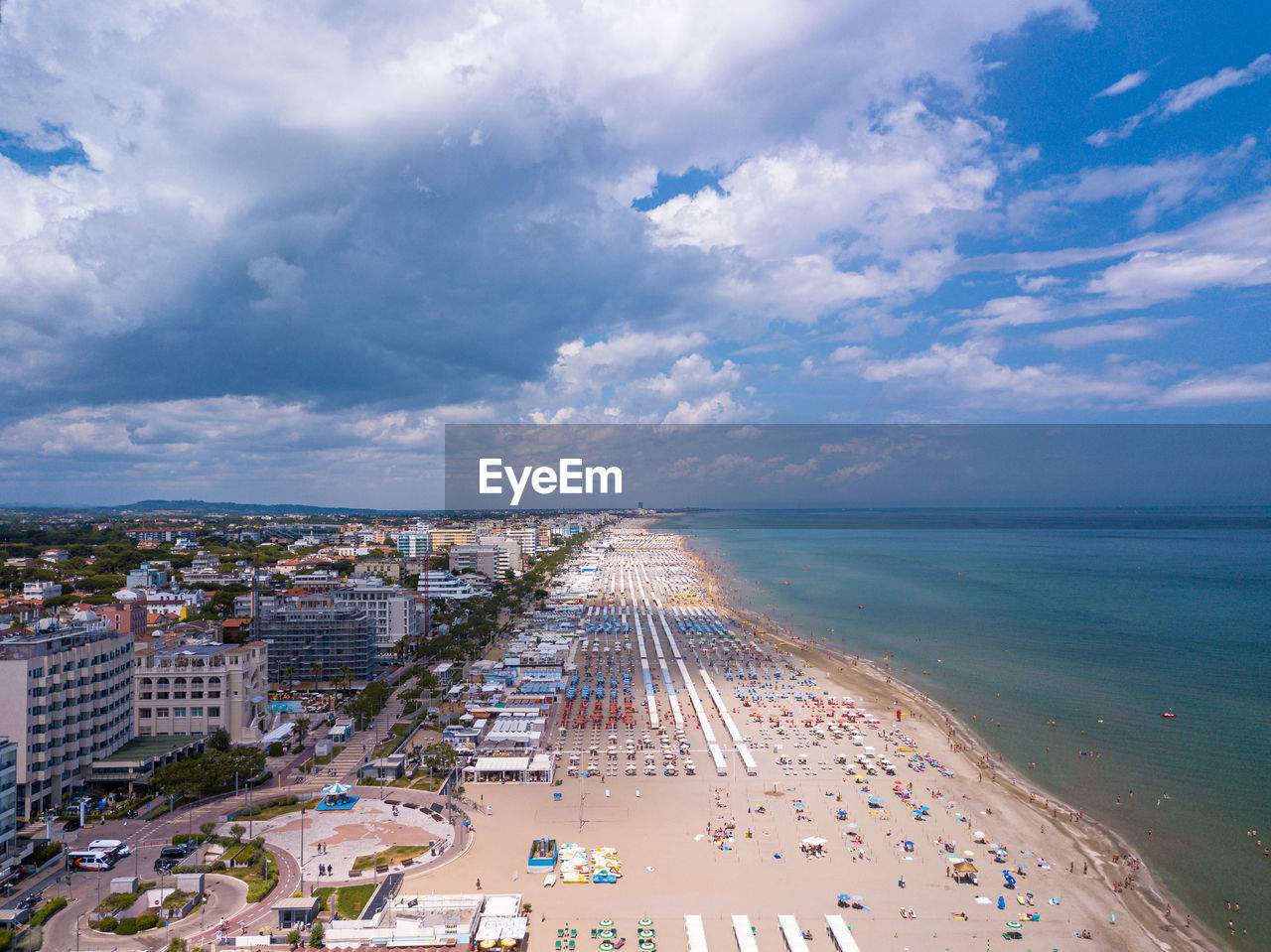 High angle view of sea and city against sky