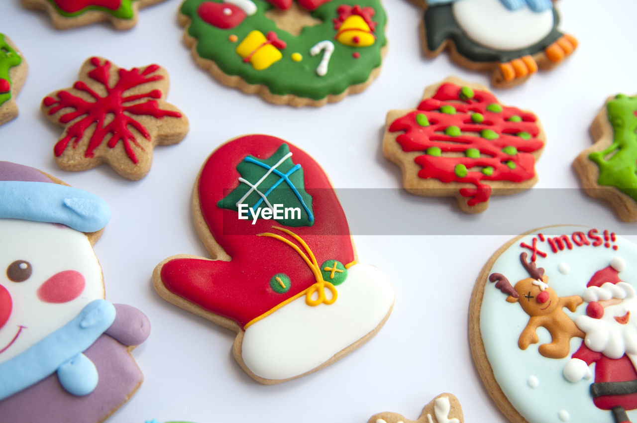 Multi colored gingerbread cookies during christmas on white background