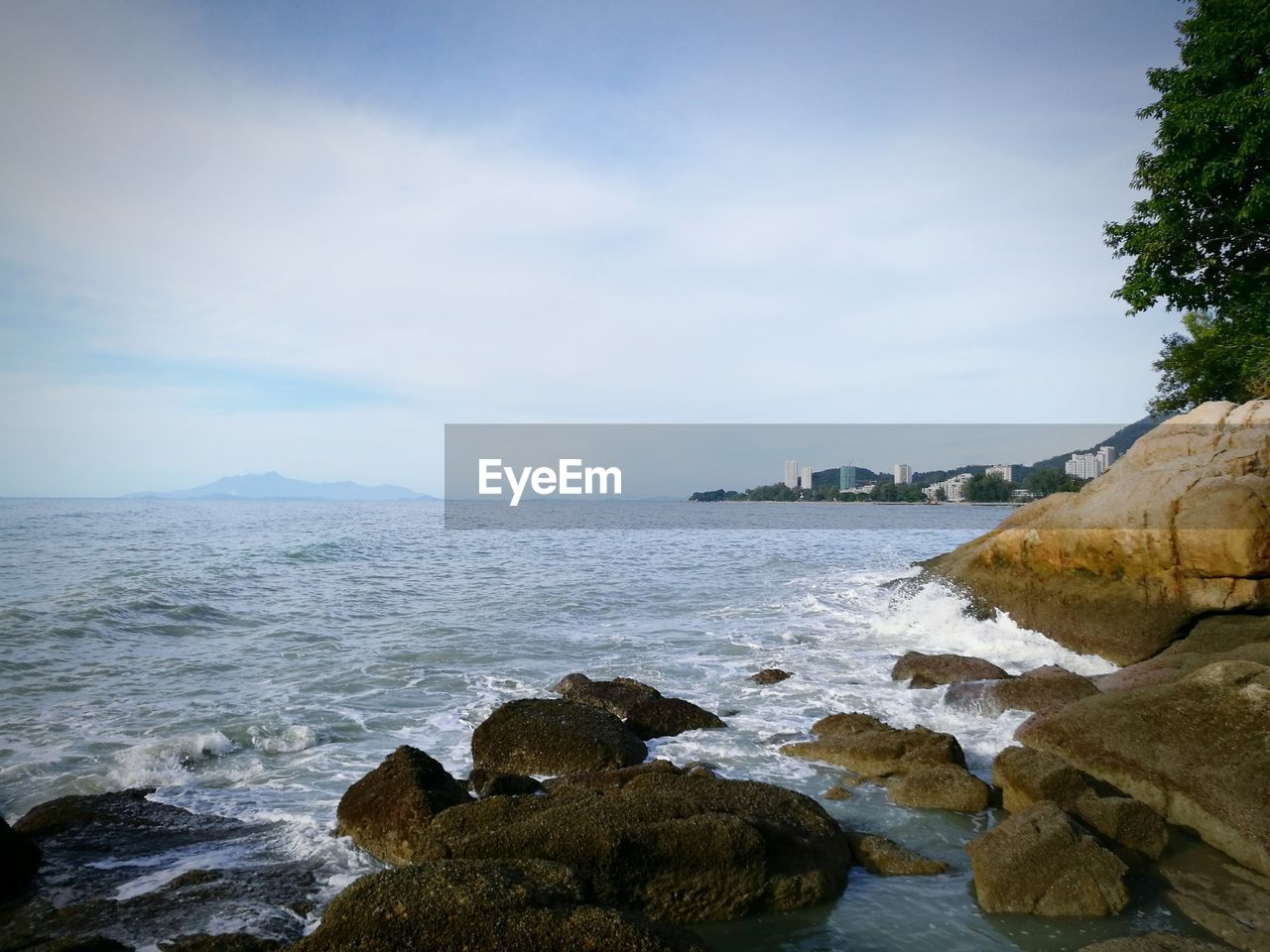 Scenic view of sea against cloudy sky