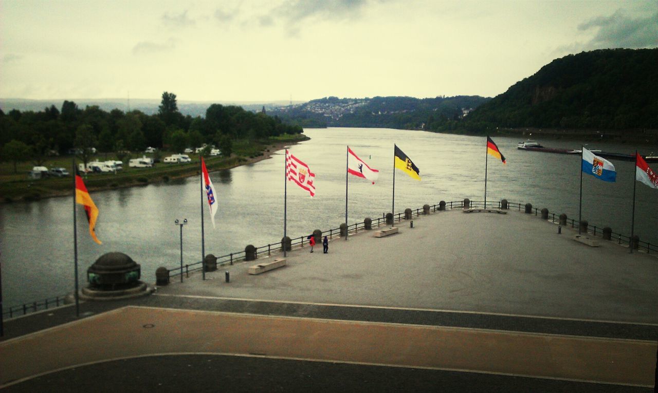 Landscape of a river with flags