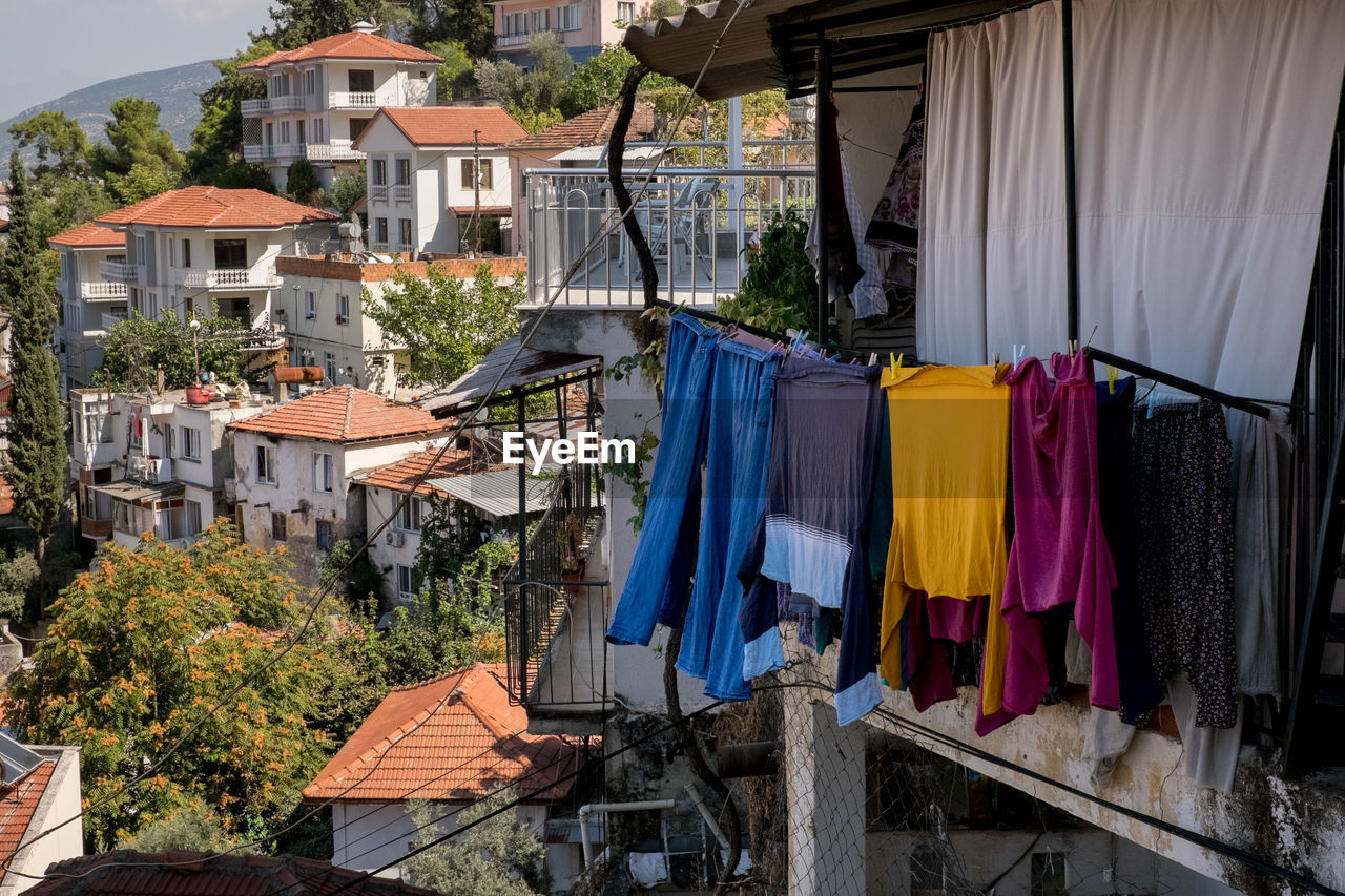 Clothes drying on clothesline by buildings in town