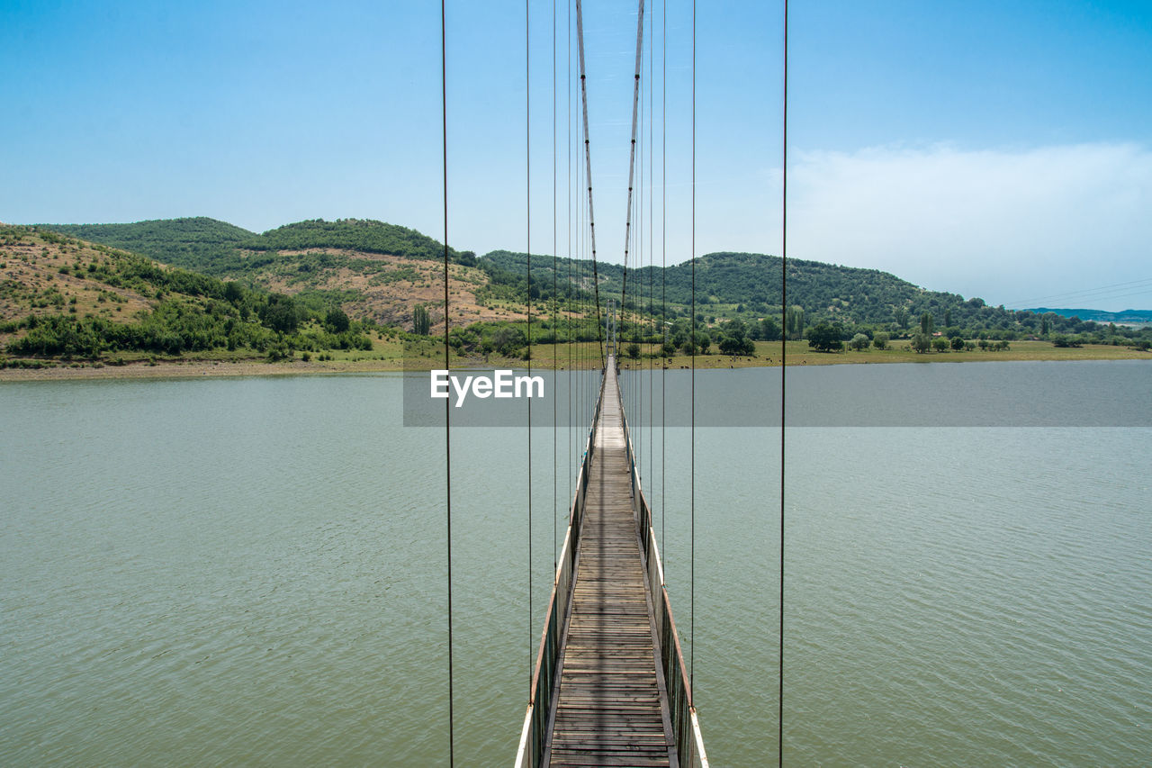 Bridge over river against clear sky