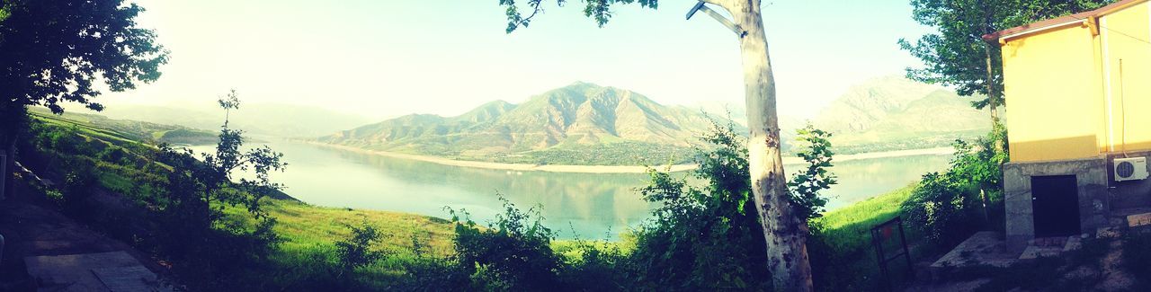 Panoramic shot of river by mountains against sky