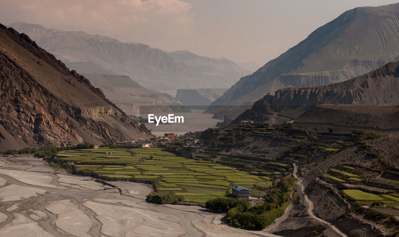 High angle view of mountain range against cloudy sky