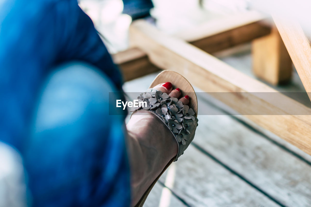 Low section of woman wearing sandal