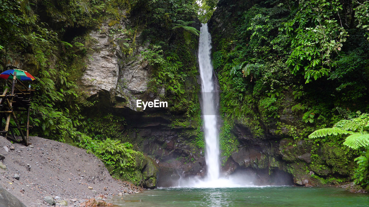 Tropical tuasan falls in mountain jungle. waterfall in the tropical forest.