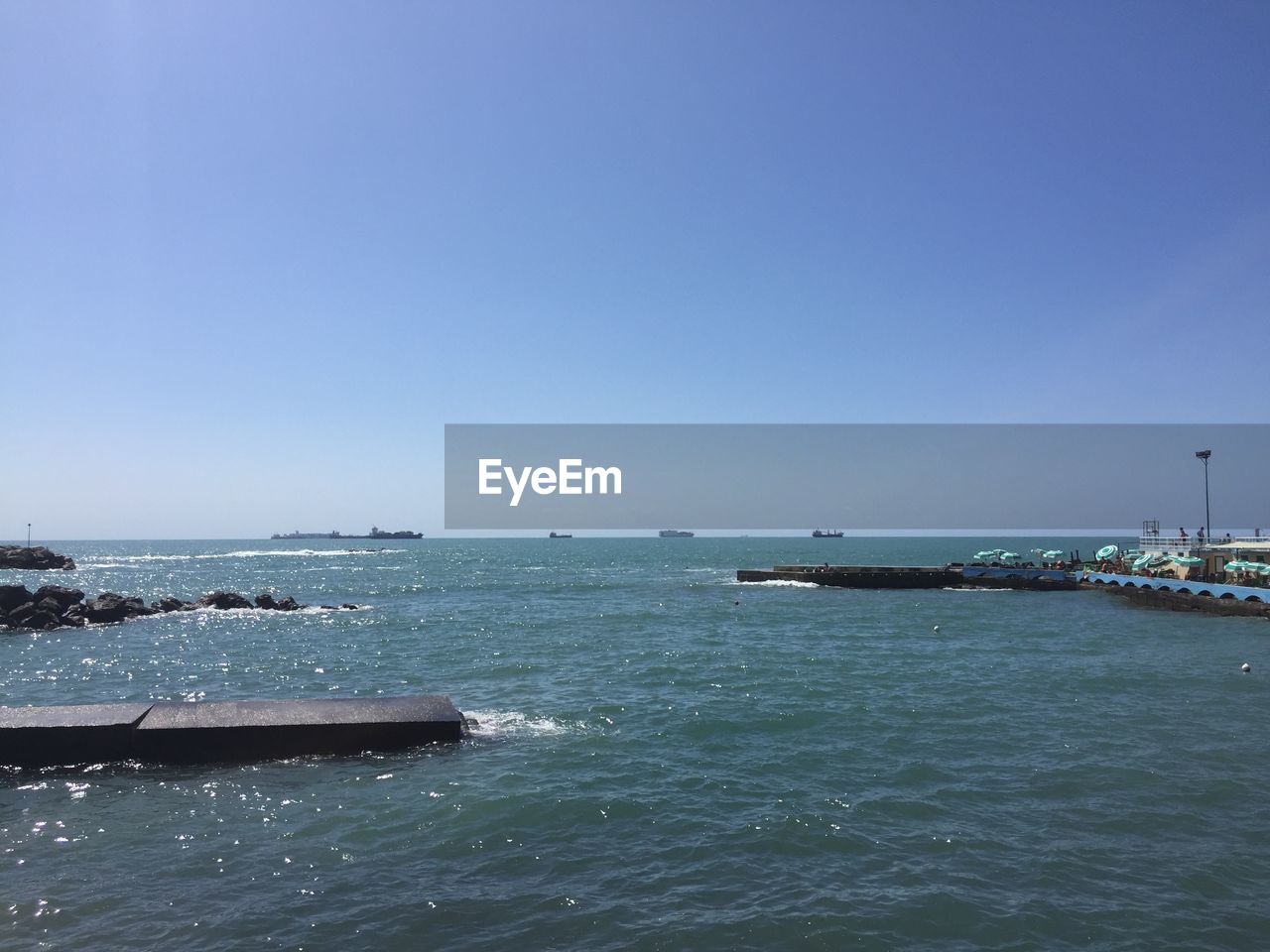 Scenic view of sea against clear blue sky