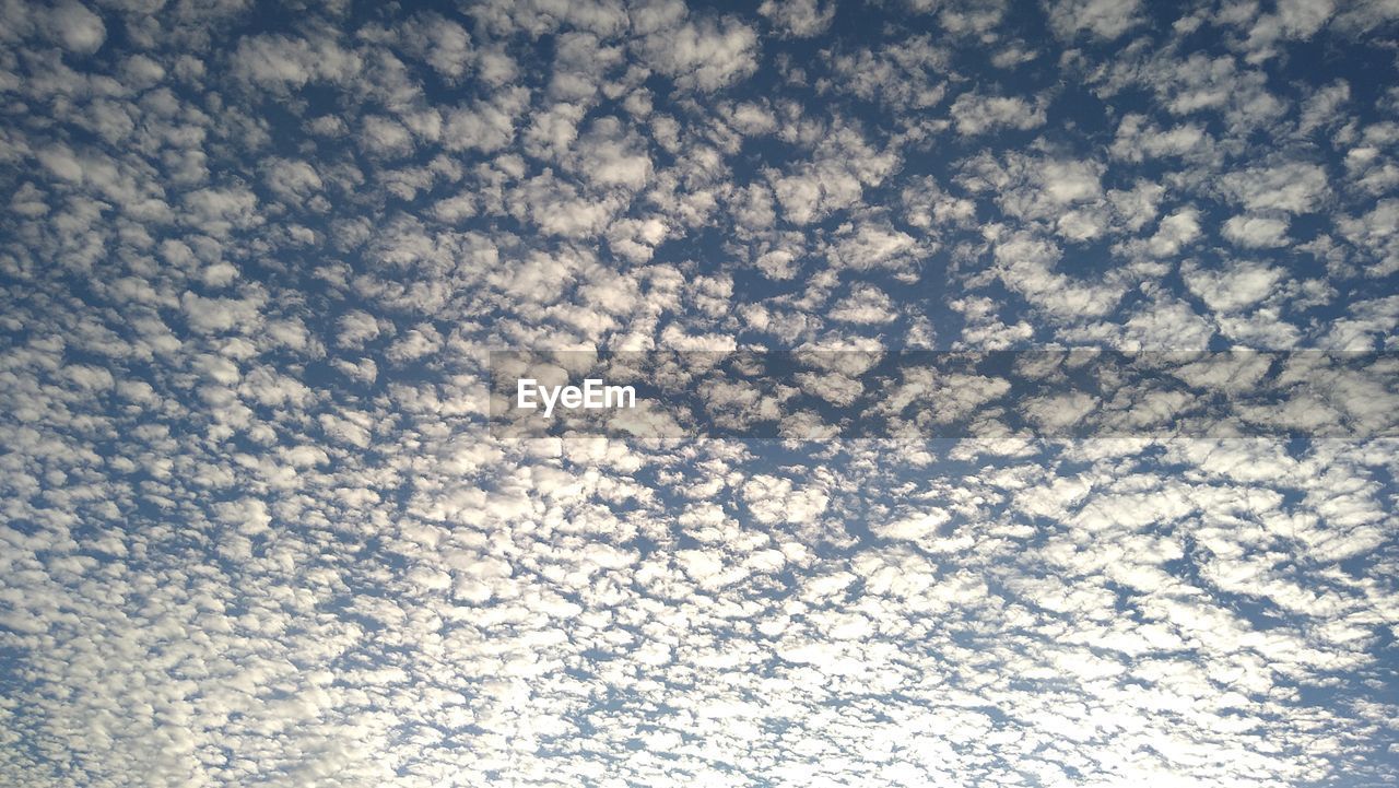 sky, cloud, backgrounds, no people, blue, sunlight, full frame, pattern, nature, low angle view, textured, day, reflection, line, outdoors, beauty in nature, abstract, wave
