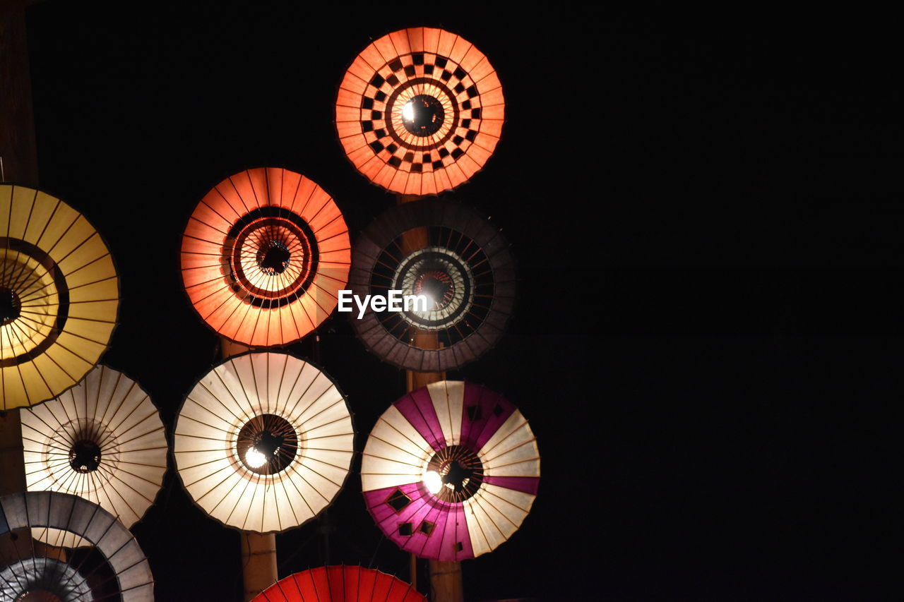 Low angle view of illuminated lights hanging from ceiling