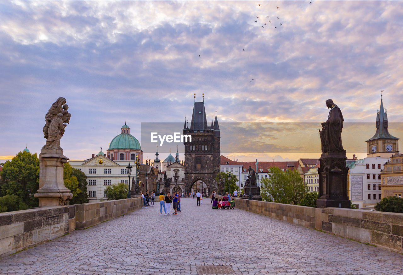 Charles bridge, old town tower and statues at sunrise, prague, czech republic