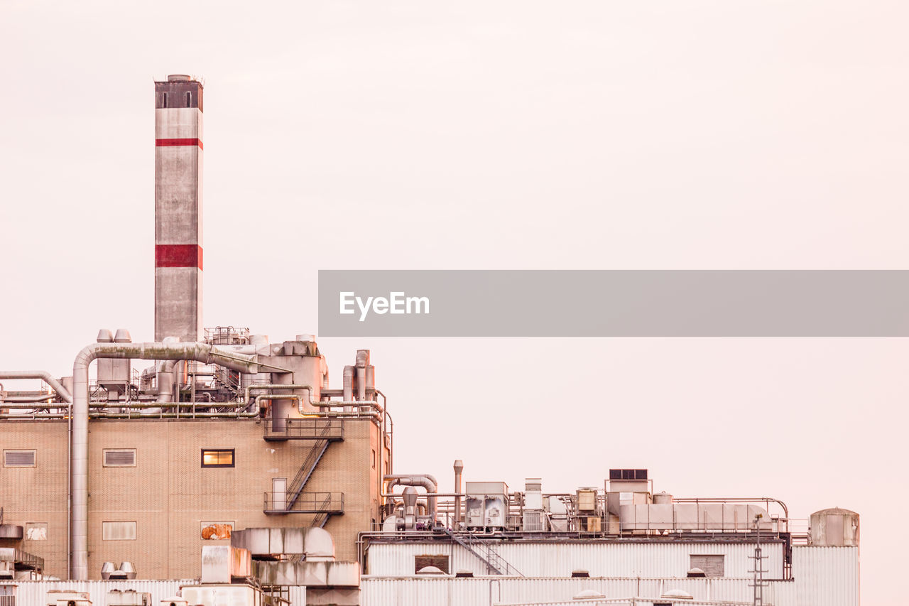 Low angle view of factory against clear sky