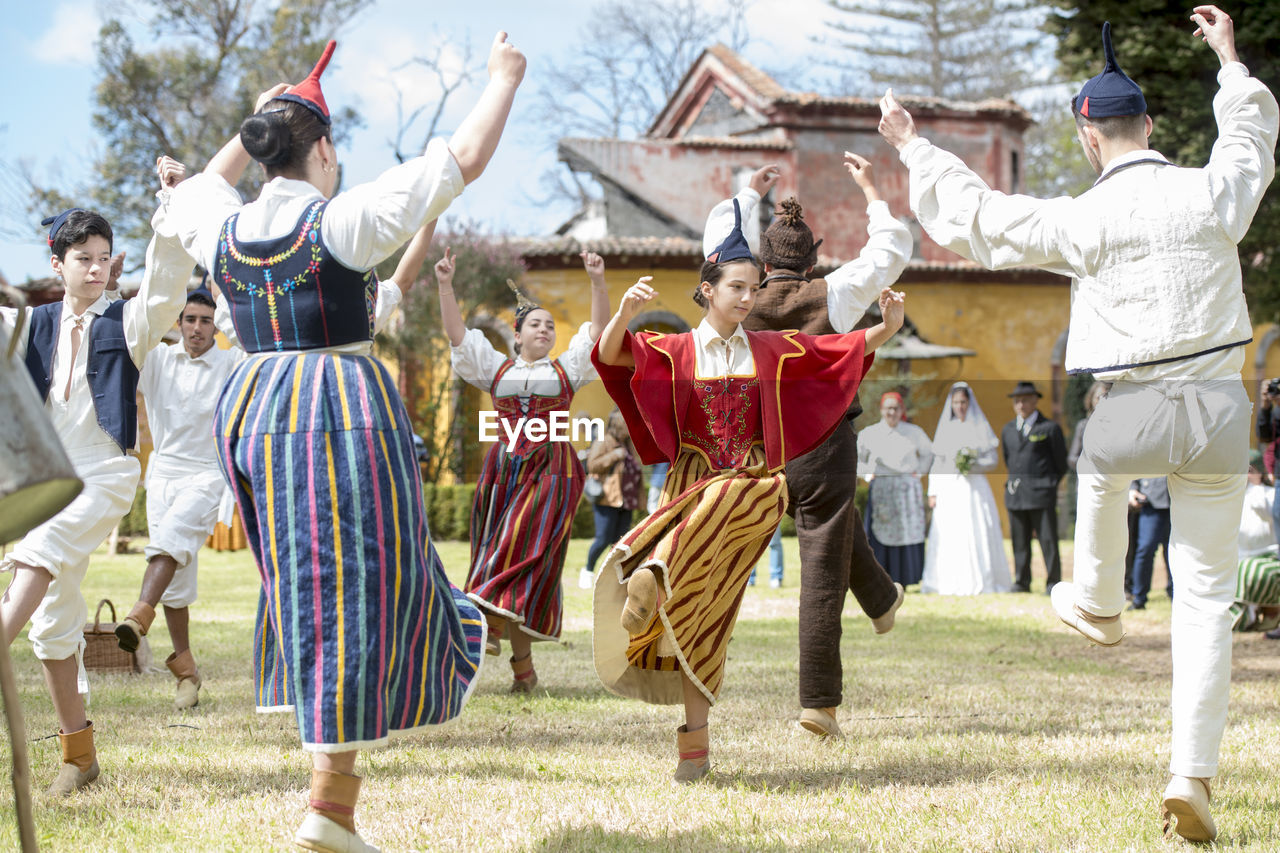 GROUP OF PEOPLE IN TRADITIONAL CLOTHING