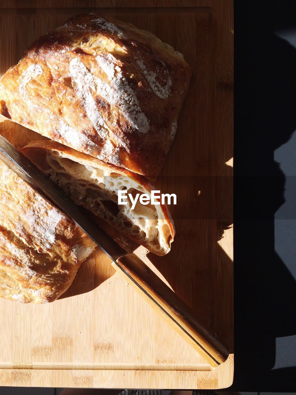 High angle view of bread with knife on tray