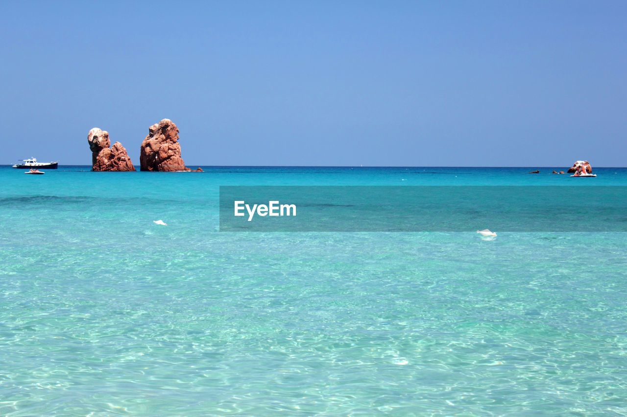 Scenic view of sea against clear blue sky