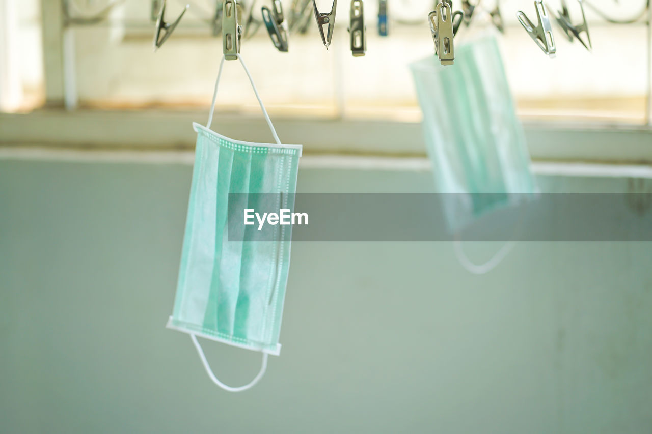 CLOSE-UP OF CLOTHESPINS HANGING ON CLOTHESLINE