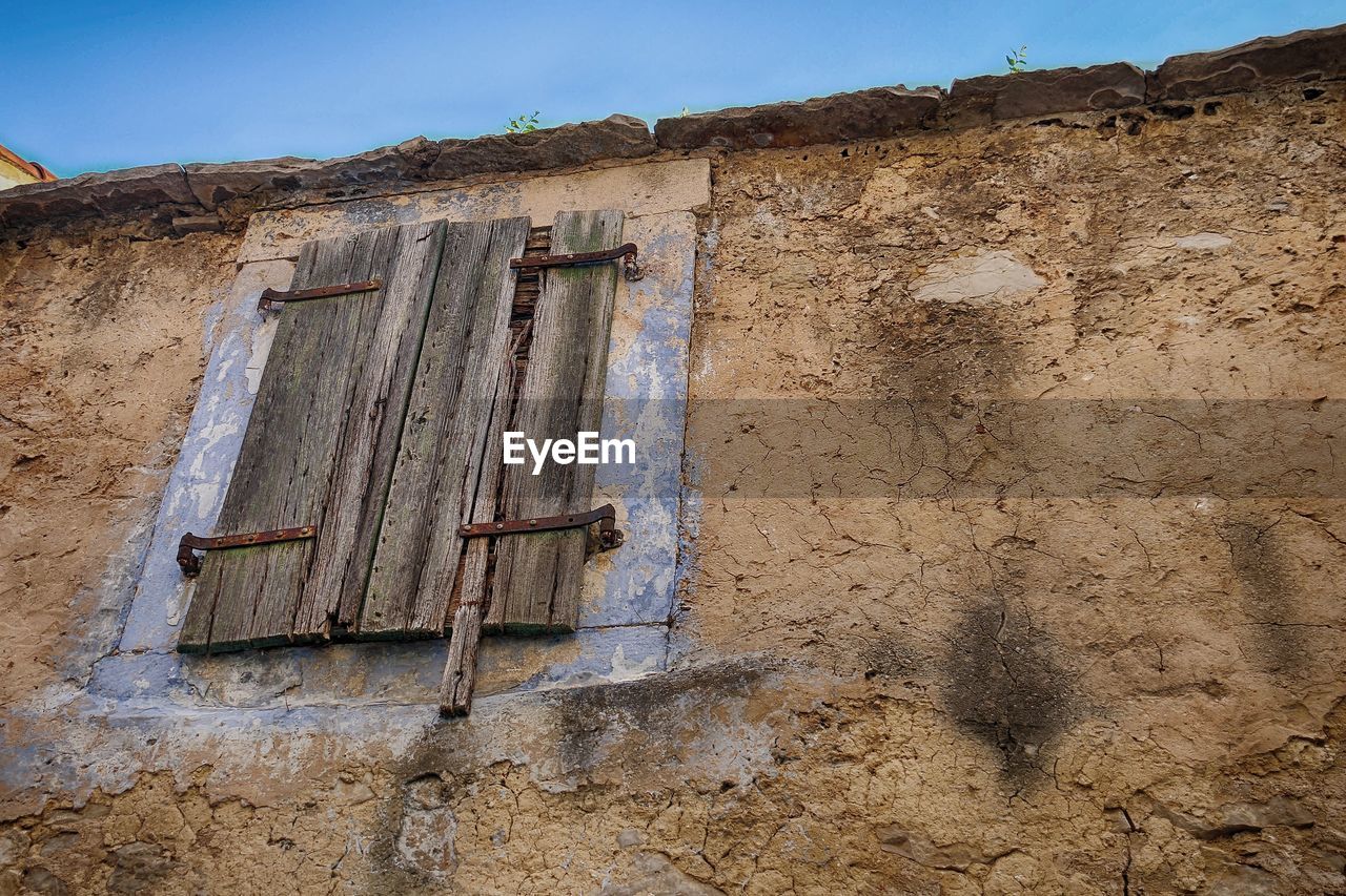 Low angle view of weathered wall