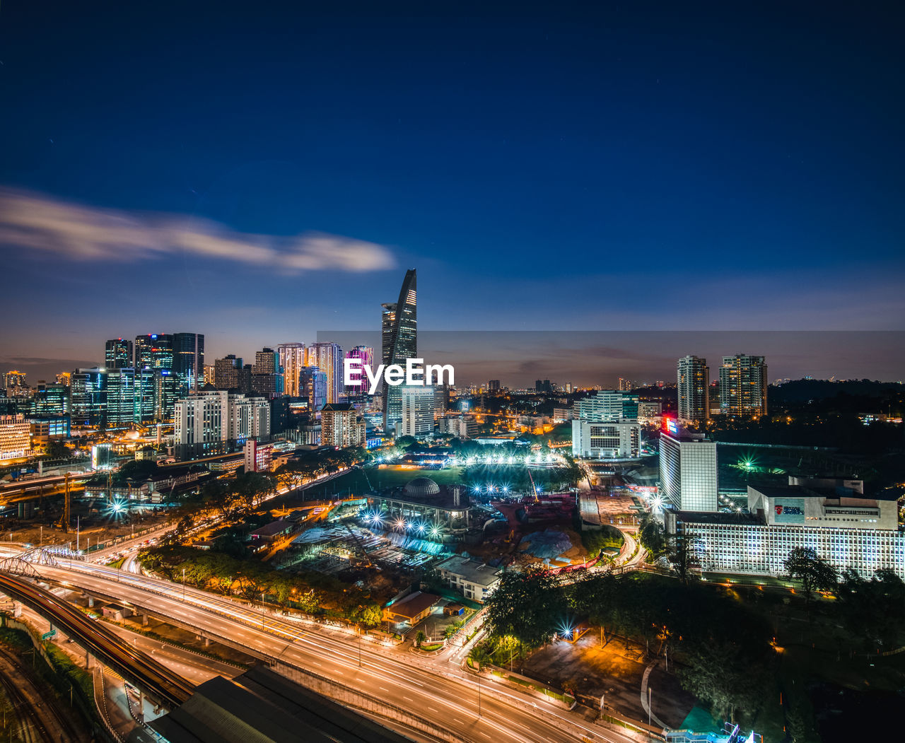 High angle view of illuminated buildings against sky at night