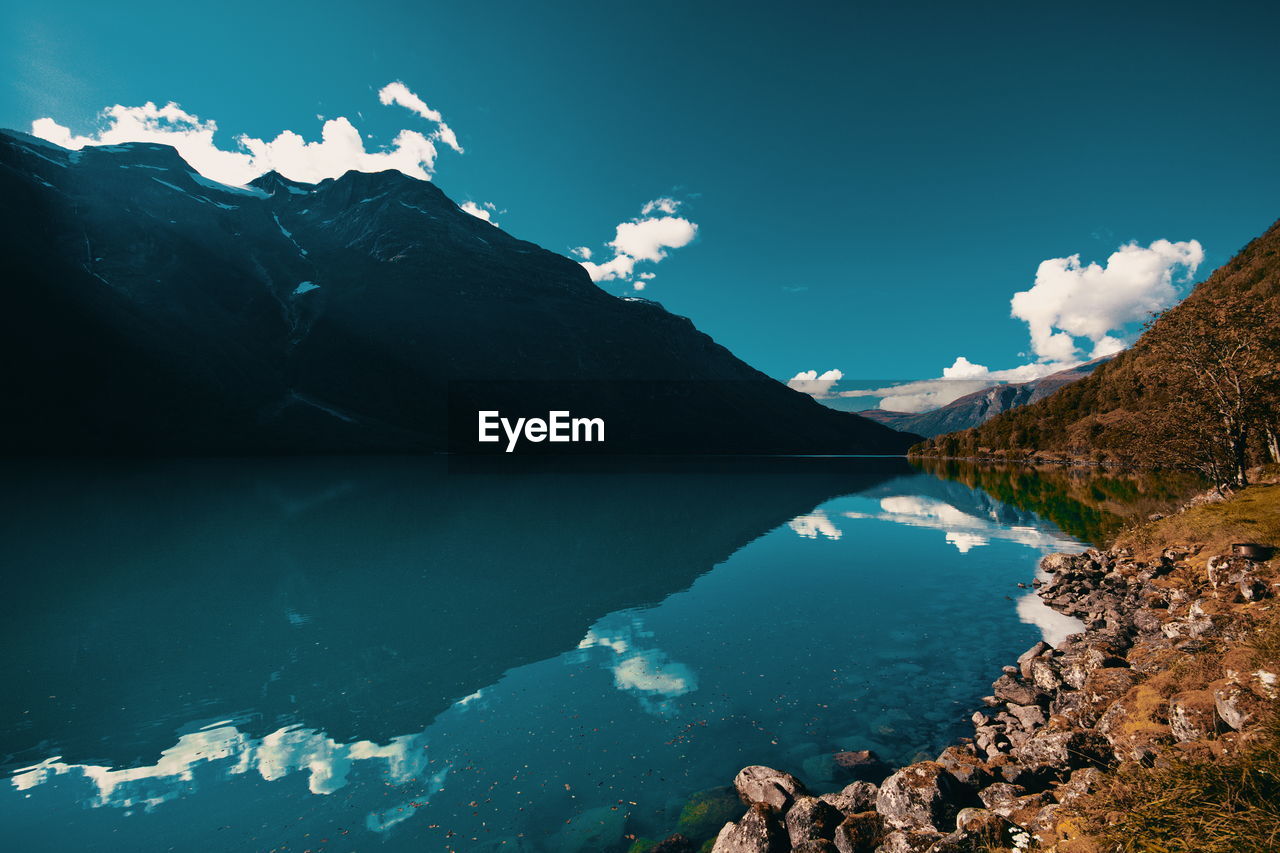 Scenic view of lake and mountains against sky