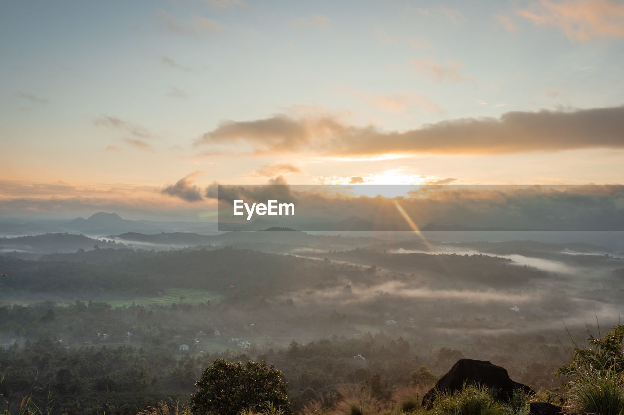 Mountain layers covered with white mist at dawn