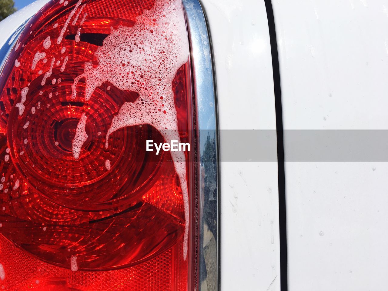 Close-up of soap sud on car headlight